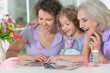© aletia2011 - Happy mother,  grandmother and granddaughter  with magazine