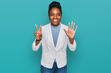 Canvas Print - Young african american woman wearing business clothes showing and pointing up with fingers number seven while smiling confident and happy.