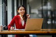 © David - Shot of an Asian young business Female working on laptop computer in her workstation.Portrait of Business people employee freelance online marketing e-commerce telemarketing concept.