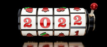 2022 Red, Black And Golden Vintage Slot Machine Isolated On The Black Background. New Year Casino Concept - 3D Illustration 