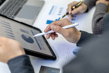 The atmosphere in the conference room was attended by two businessmen, a joint company operating brainstorming meeting for business growth, They are looking at data from the tablet.