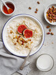 Oatmeal porridge with figs, nuts and honey. Healthy breakfast food. Eating healthy breakfast porridge oats.