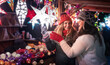 © Kzenon - Two friends buying Christmas decoration on winter market booth