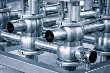 Poster - Pipelines from stainless steel, a system for pumping liquids or milk for the food industry. Abstract industrial background.