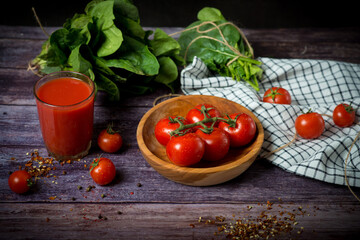 cherry tomatoes and tomato juice on a black background