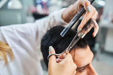 lock of hair getting cut off with scissors from head