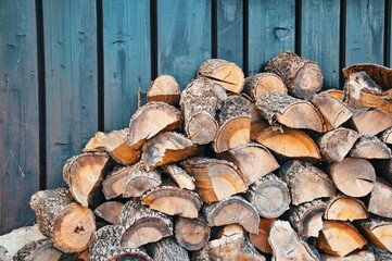 Pile of firewood against wooden background