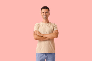 Wall Mural - Handsome young man in stylish t-shirt on color background