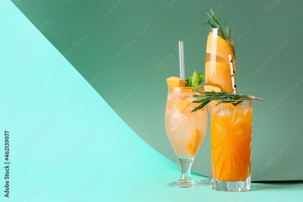 Glasses with different melon cocktails on color background