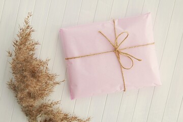 Wall Mural - Pink wrapping paper package with ribbon, mockup for thank you sticker, logo or address label presentation.