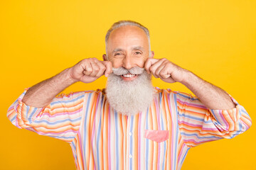 Sticker - Portrait of attractive cheerful well-groomed grey-haired man touching mustache isolated over bright yellow color background