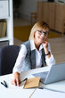 © Westend61 - Mid adult businesswoman sitting at desk in office