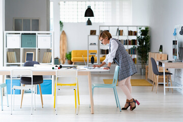 Female professional working on laptop at desk