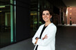 © Westend61 - Smiling confident businesswoman standing with arms crossed