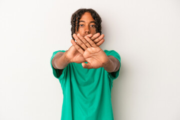 Young african american man isolated on white background doing a denial gesture