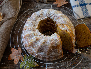 Wall Mural - Bundt cake with pumpkin and hazelnuts on a cooling rack