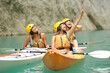 © Antonioguillem - Three friends in kayak enjoying views in a lake