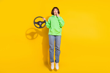 Wall Mural - Full length body size view of attractive girl jumping holding steering wheel pout lips isolated over bright yellow color background