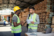 © Drazen - Warehouse manager gives instructions to young black worker while going through checklist.
