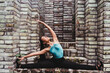 © VISTA by Westend61 - Young female dancer doing stretching on steps