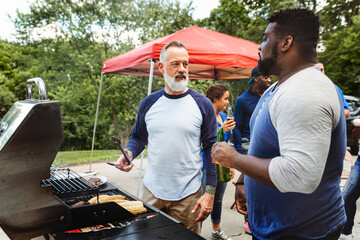 Wall Mural - Manning the grill at a tailgate party