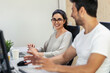 © nenetus - Successful business team working together with computer while talking in coworking place.