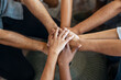© nenetus - Hands of successful smart business team celebrating good job while holding up their right hands on coworking place.