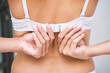 © elenavolf - Young woman showing manucure hands. Closeup view. Female underware. Undress bra self. Remove lady back clothes