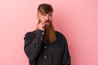 © Asier - Young caucasian ginger man with long beard isolated on pink background with fingers on lips keeping a secret.