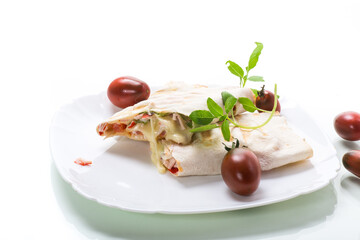 Sticker - baked pita roll with filling in a plate on the table