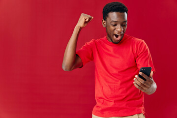 emotional man african appearance with phone in hands technology communication joy