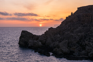 Poster - Sunset on a beautiful spring day with calm sea, seen from Anchor Bay, Mellieha, Malta.