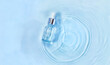 Cosmetics in a bottle in water, skin hydration concept. Hyaluronic acid. Selective focus.