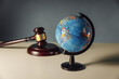 Concept of world justice. Wooden gavel and globe on a table