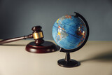 Fototapeta Mapy - Concept of world justice. Wooden gavel and globe on a table