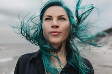 Portrait Of A Beautiful Woman With Blue Hair That Flutters In The Wind