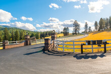 A Winding Gated Road Or Path With White Fence In A Rural Community Of Luxury Homes On Acreage At Autumn In The Saltese Uplands And Flats Area Of Spokane, Washington, USA.