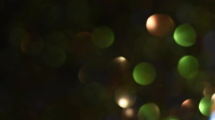Wall Mural - Slow movement of light over multicolor bokeh with fading. Rounds of illuminated light move from right to left on a green, brown and blue circles backdrop. HD LOOP. Can be used as background or overlay