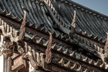 Wall Mural - Bangkok, thailand - Dec 30, 2019 : A pigeons perched on the Old wooden roof at chapel at chong Nonsi buddhist temple (Wat Chongnonsi) in rama3 road.