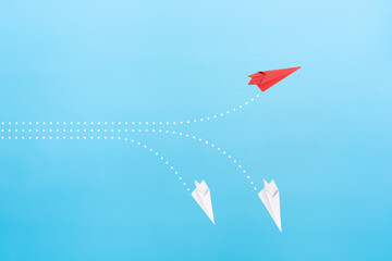 Wall Mural - Successful red paper plane on blue background