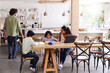© Southworks - Family in kitchen with sons doing homework