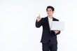 © Thinapob - successful Happy of asian young businessman a successful business hold laptop computer with pointing hand gestures finger touch imagery panel isolated on white grey blank copy space studio background