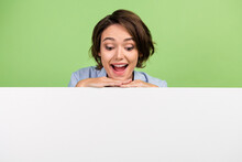 Photo Of Amazed Positive Young Happy Woman Look Empty Space Banner White Copyspace Isolated On Green Color Background