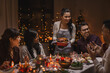 © Syda Productions - holidays and celebration concept - multiethnic group of happy friends having christmas dinner at home