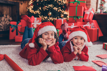 Poster - Portrait of two nice attractive cheerful people siblings lying on carpet resting eve festal occasion at home indoors