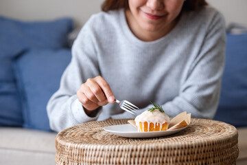 Wall Mural - A woman eating a piece of lemon pound cake