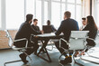 © xartproduction - Group of young business people working and communicating while sitting at the office desk together with colleagues sitting. business meeting