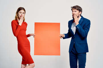 Wall Mural - man and woman holding red mockup copy space advertising poster