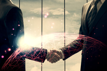 Double exposure of social network theme hologram and handshake of two men.