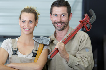 Wall Mural - man and woman holding tools